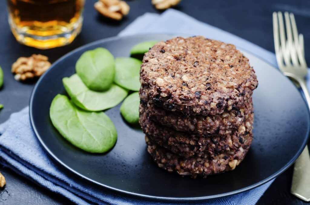 black beans brown rice walnut oat burgers with spinach. toning. selective focus