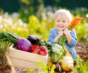 8 Reasons to Adopt a Plant-Based Diet, child hugging a bunch of carrots